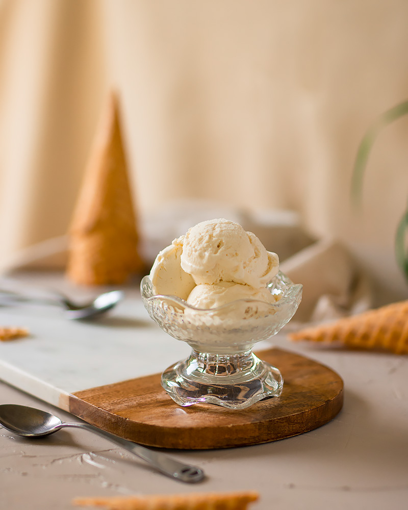 Styled product photo of Vanilla Ice Cream surrounded by sugar cones