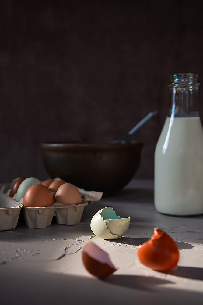 Lifestyle Photo of baking Ingredients, eggs, milk , and a bowl with whisk